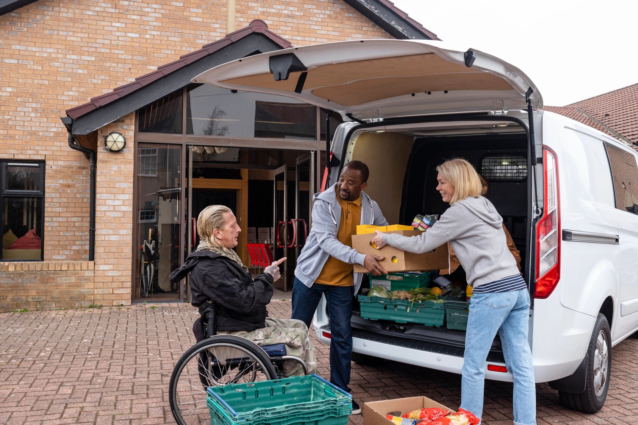 Team unloading food service supplies from a van