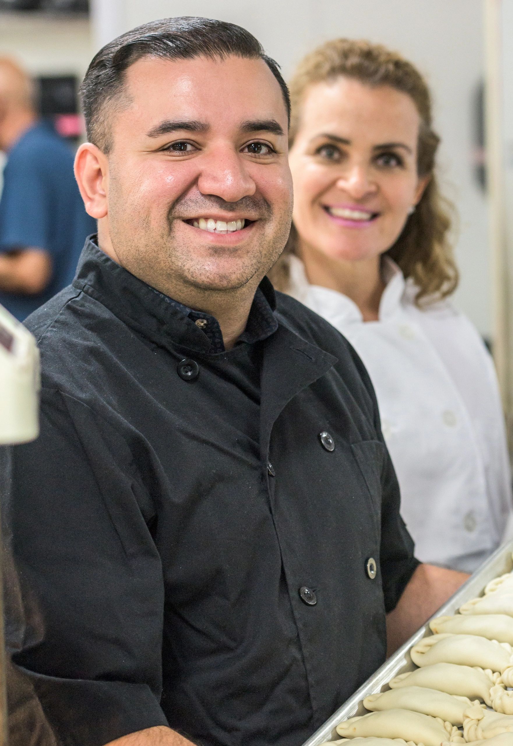 Friendly deli workers smiling together