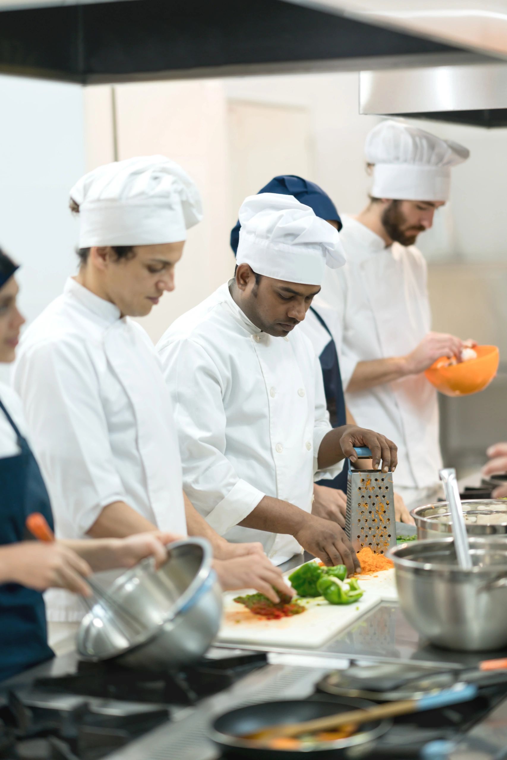 Team members preparing meals in a professional kitchen
